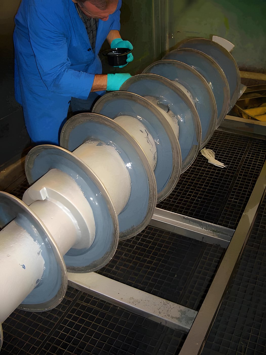Protective coating on the scroll of a decanter centrifuge